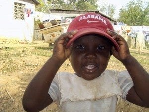Haitian Girl wearing Alabama Crimson Tide cap Photo provided by UA
